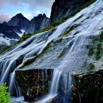 Flowing water from creek creating mini waterfall, Cirque of Unclimbables, Nahanni National Park, Northwest Territories