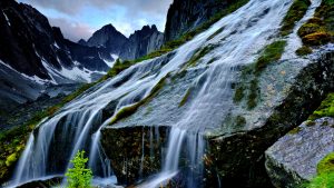 Flowing water from creek creating mini waterfall, Cirque of Unclimbables, Nahanni National Park, Northwest Territories